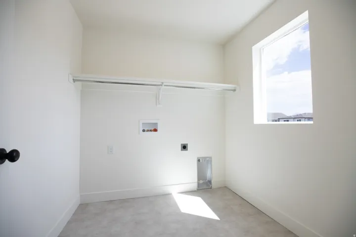 Full-size, dedicated laundry room with natural light and washer/dryer hookups.