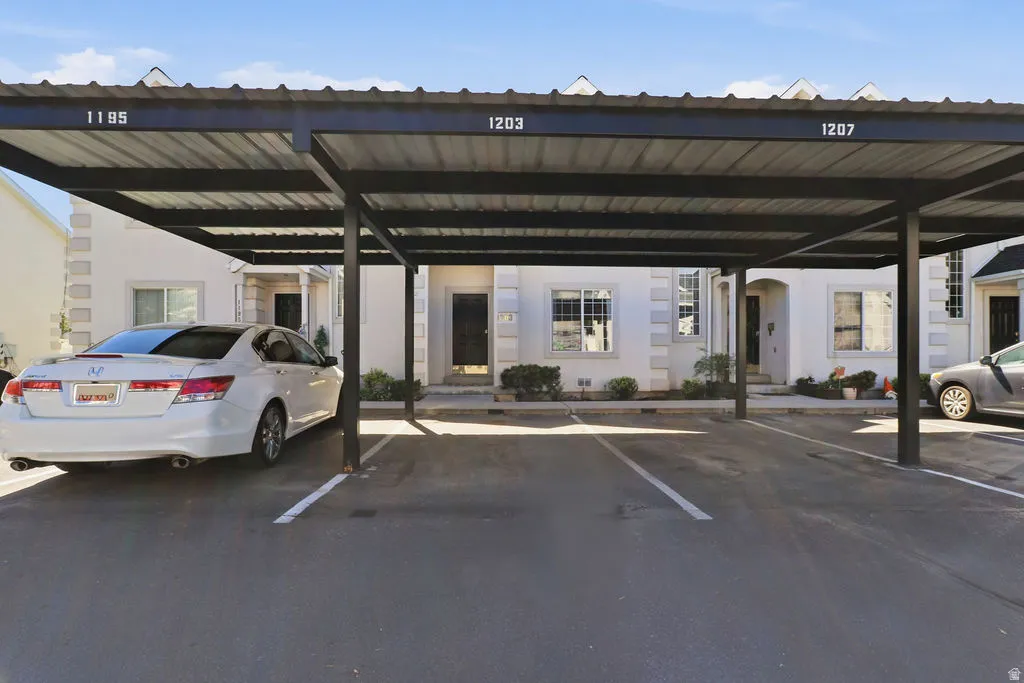 Covered parking structure with multiple spaces and asphalt paving