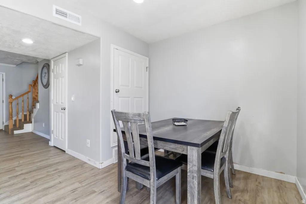 Wood-finish flooring throughout, white interior doors, and recessed ceiling lighting