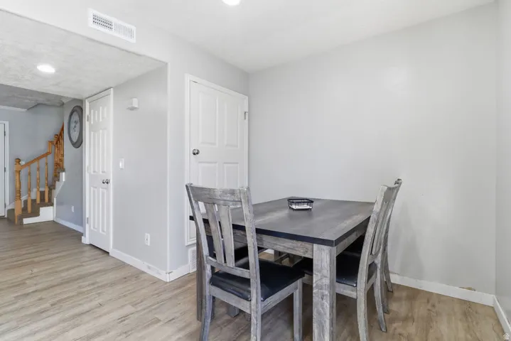 Wood-finish flooring throughout, white interior doors, and recessed ceiling lighting