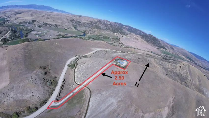 Aerial perspective of approximately 2.50 acres featuring expansive hillside terrain, mountain topography, and paved road access