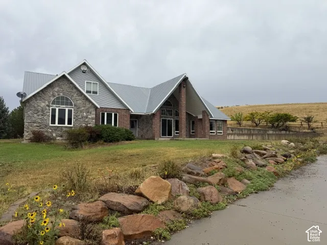 Stone and brick exterior with a metal roof