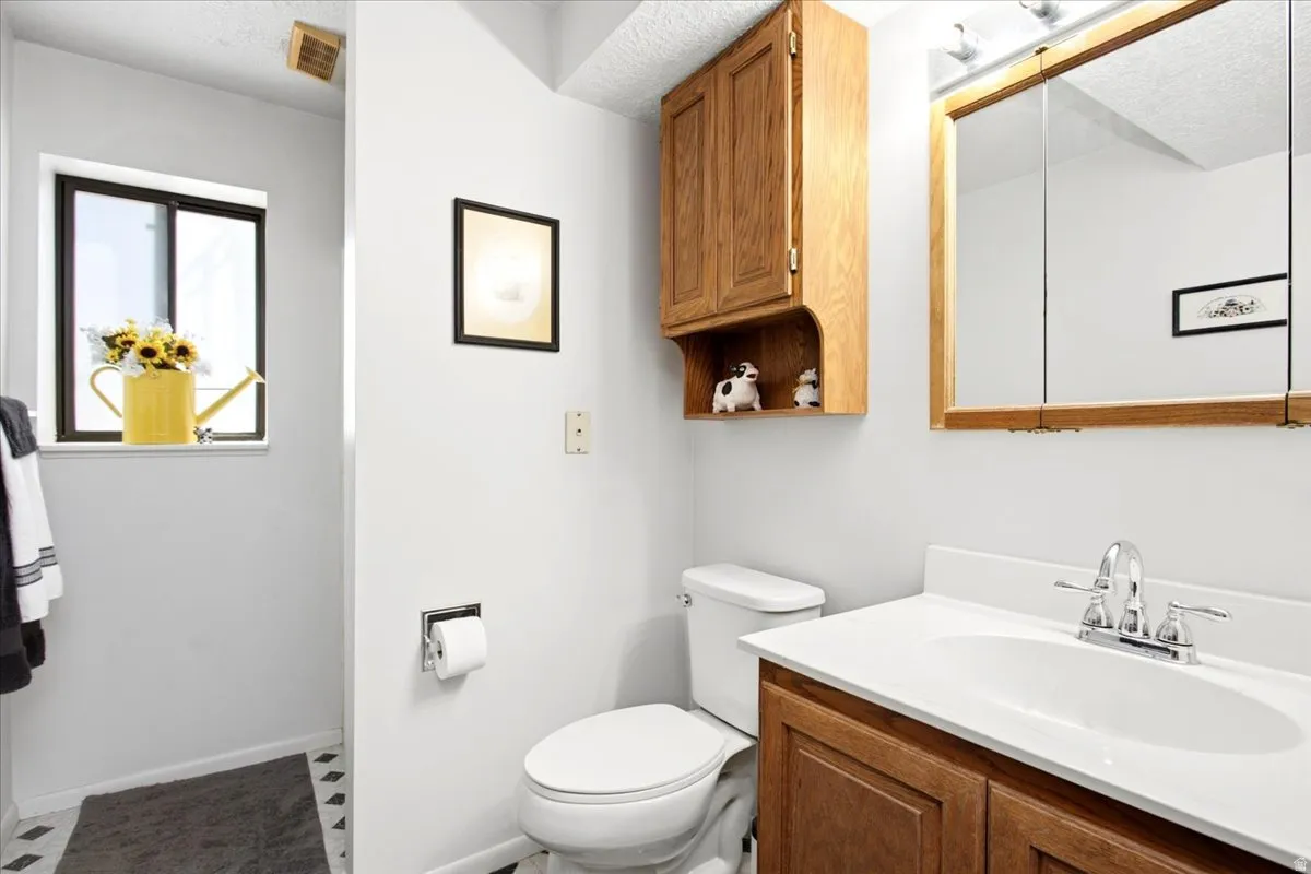 Wood-finish vanity with an integrated sink and chrome faucet