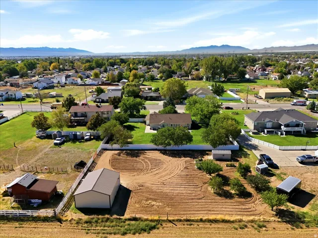 Expansive property featuring a large barn, additional outbuilding, and mature trees