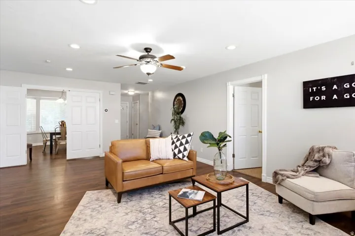 Recessed lighting, wood-finish flooring, ceiling fan, and white interior doors