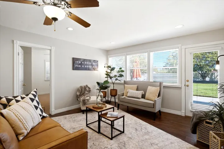 Recessed lighting, wood-finish flooring, ceiling fan, multiple windows with blinds, and a white paneled door