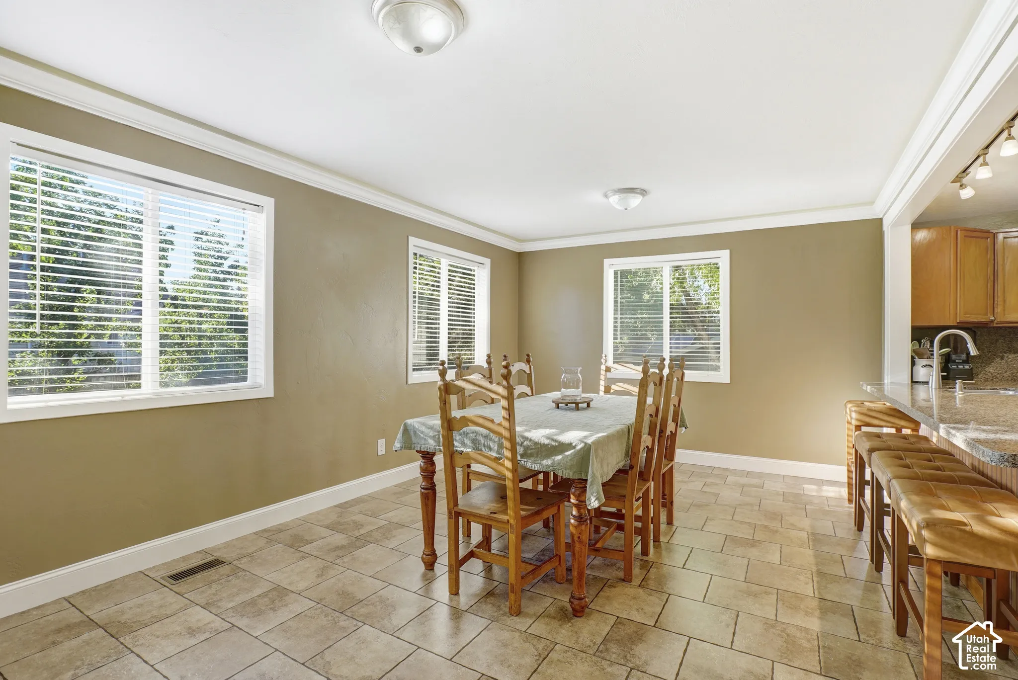 Recessed lighting, wood cabinetry, granite countertop, and tiled flooring