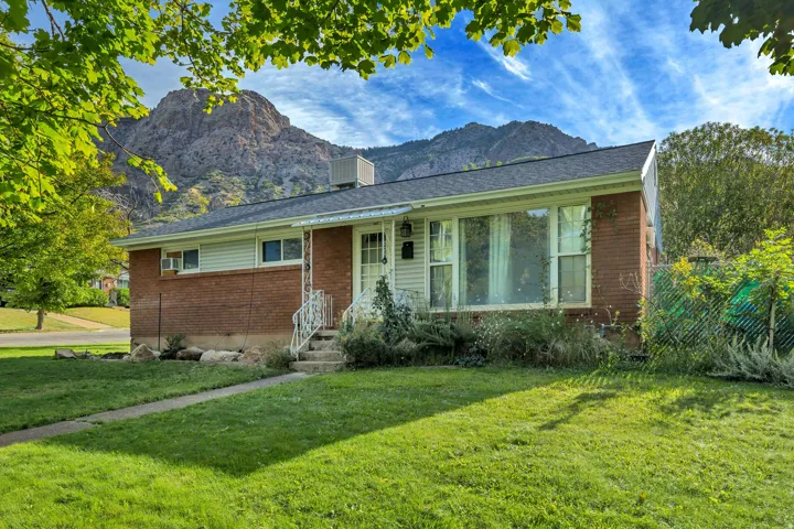 Brick and siding exterior with a large picture window