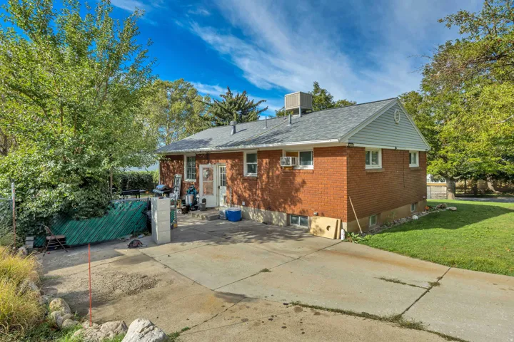 Red brick exterior with white trim windows and gray shingle roofing