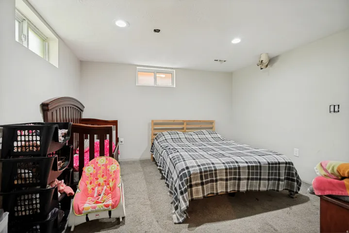 Recessed ceiling lighting, two transom windows, and light gray wall finishes