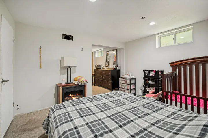 Recessed lighting, wood-finish flooring, and an electric fireplace
