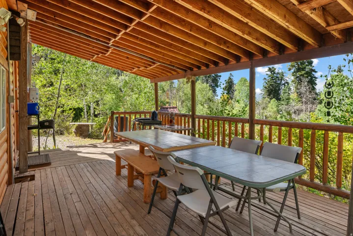 Expansive wood-plank deck with a wood-beamed ceiling