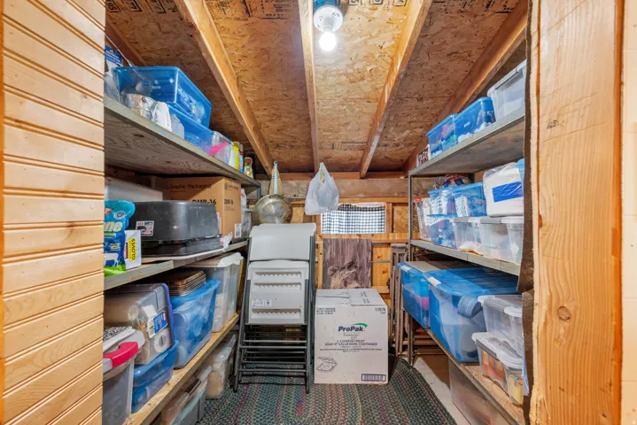 Built-in shelving units, wood plank walls, and exposed wood ceiling beams