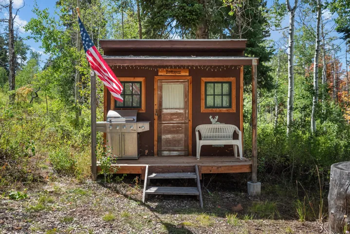 Wood-clad structure with a covered porch and wood steps