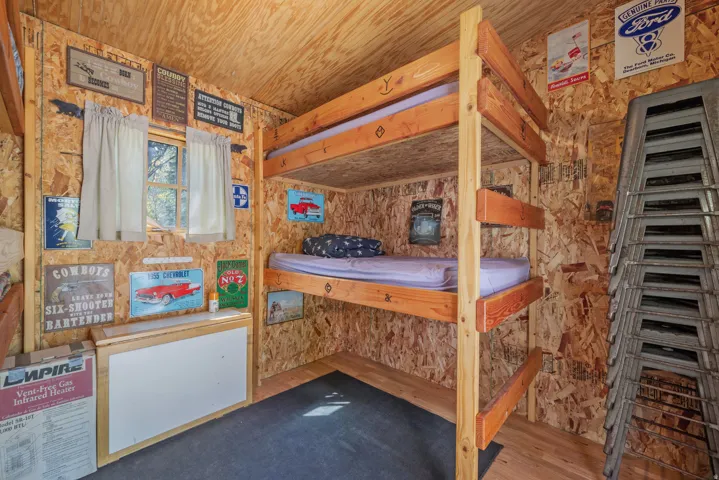 Wood-finish interior walls and ceiling with a built-in bunk bed frame