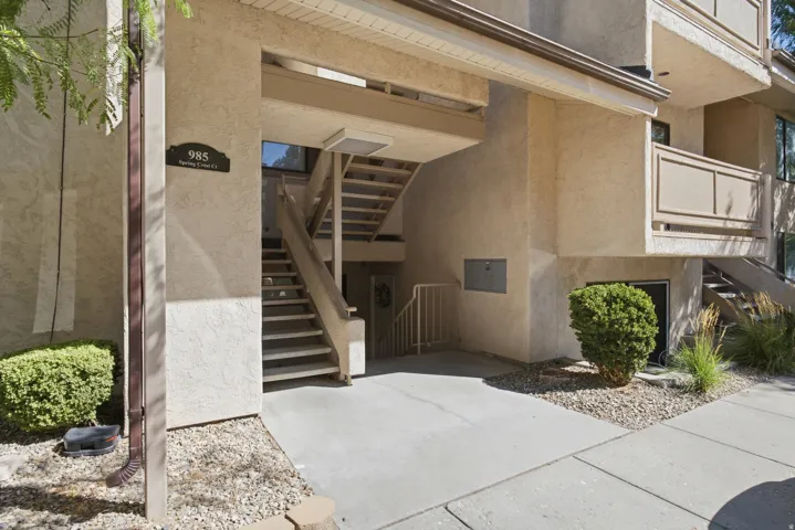 Multi-level building exterior featuring stucco siding and integrated outdoor stairways