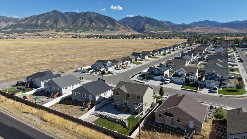 Residential community featuring multiple single-family homes with pitched roofs and attached garages