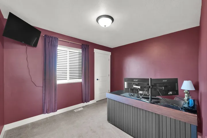 Wall-mounted television and a flush-mount ceiling light fixture
