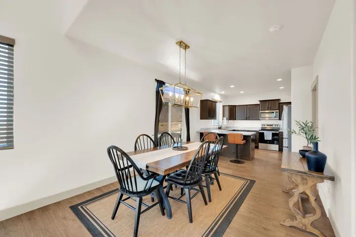 Wood-finish flooring throughout, with a window featuring blinds