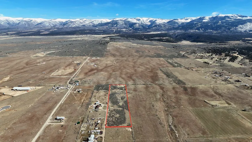Expansive land parcel with clear boundary lines, featuring varied natural terrain