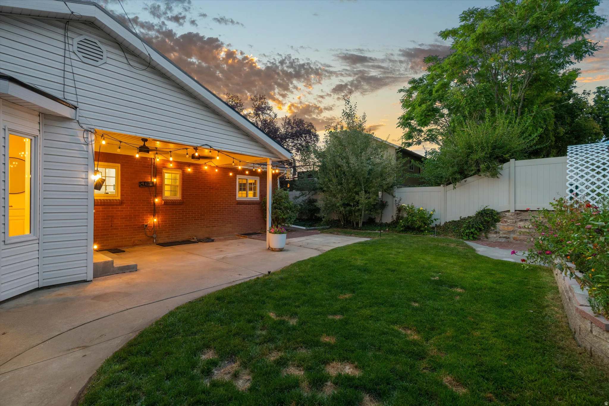 Expansive manicured lawn with a concrete patio area