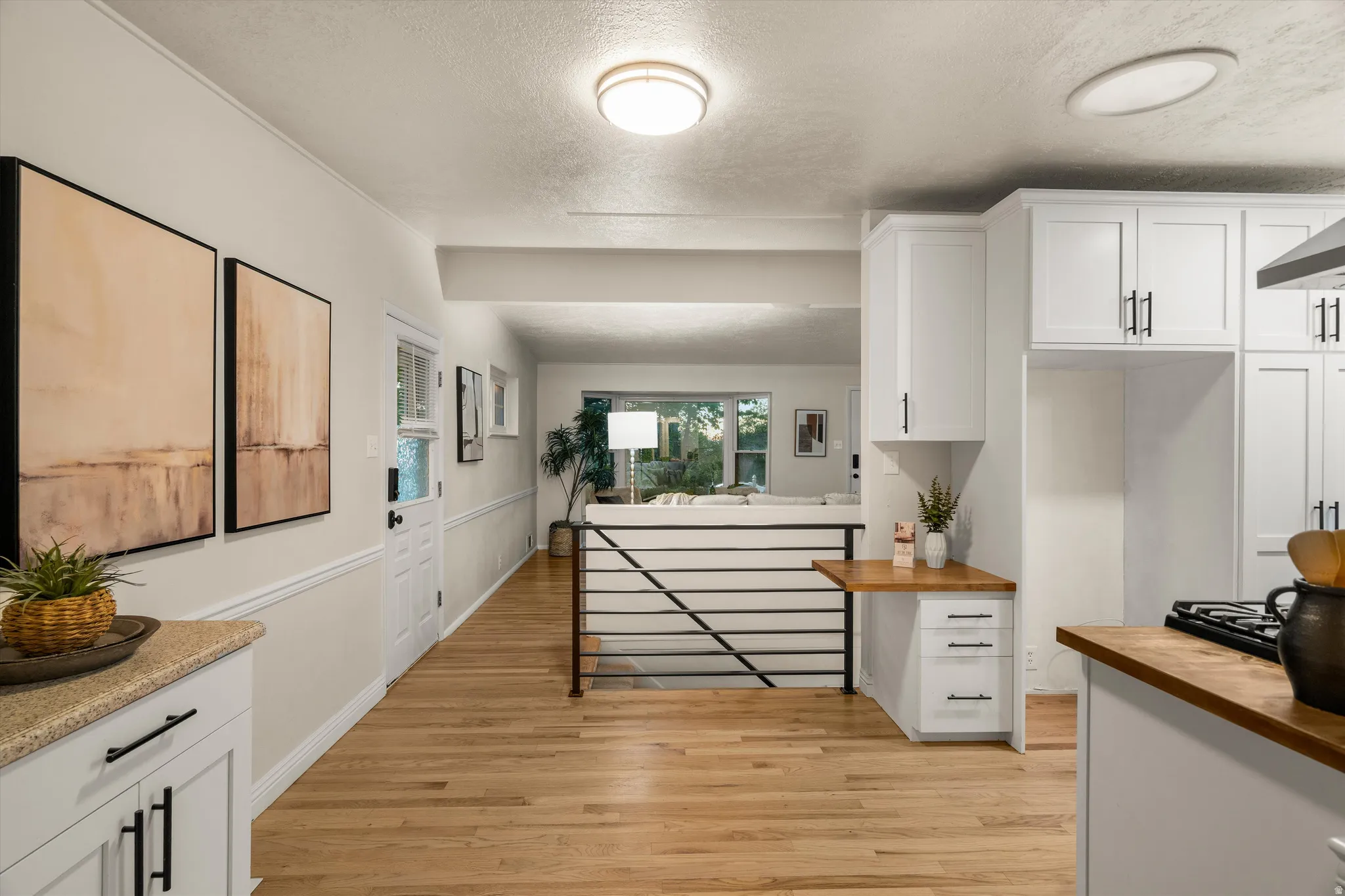 Custom cabinetry areas, rail to basement access, side door exiting to garage area