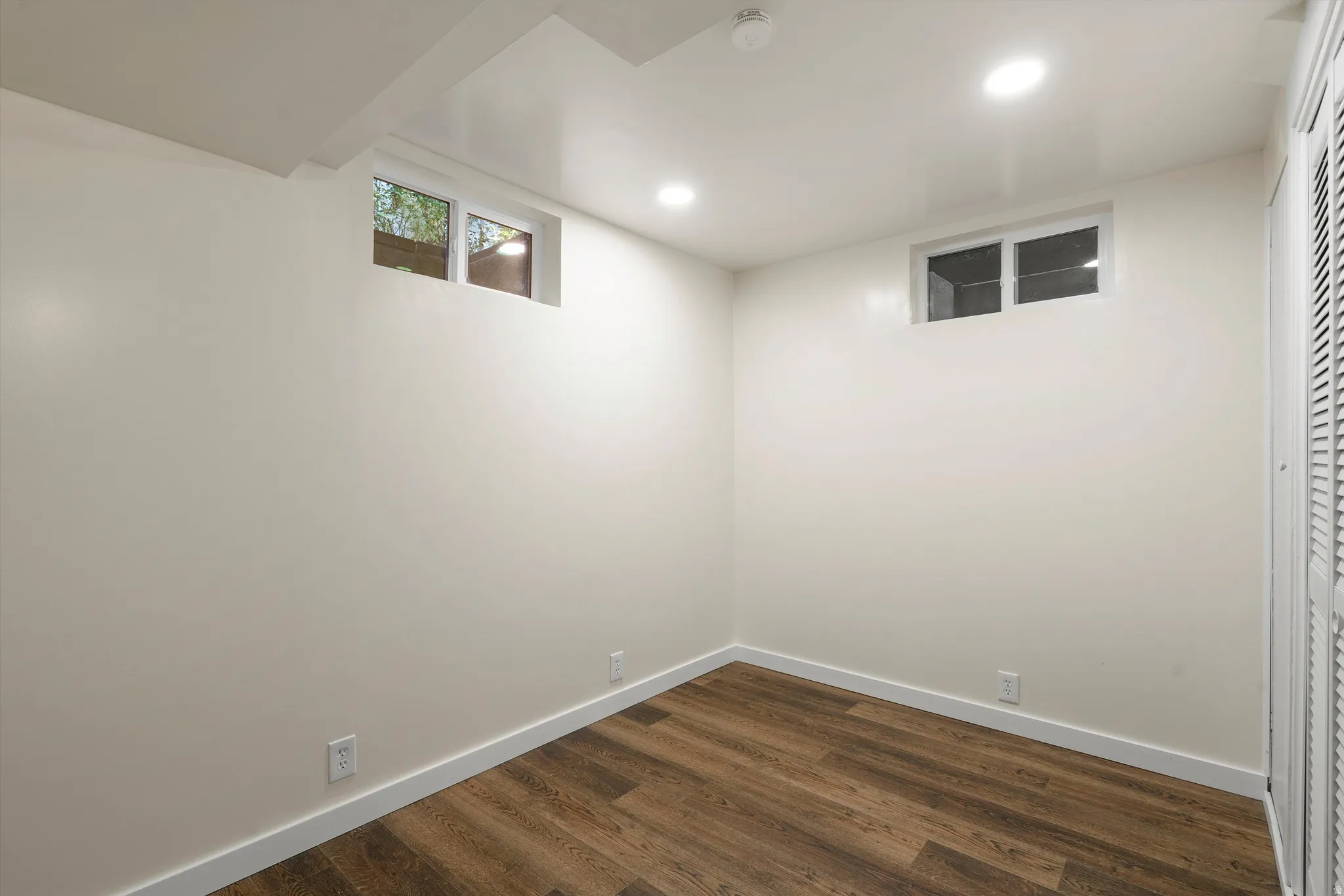 BONUS room! Recessed ceiling lighting, wood-finish flooring, and white walls