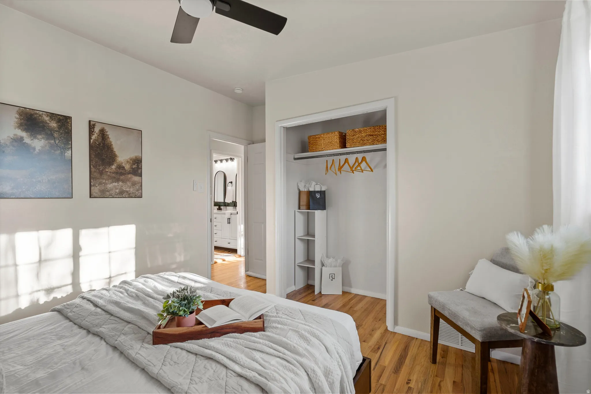 Primary Bedroom #1 Hardwood flooring, ceiling fan, white walls, and a built-in closet with shelving