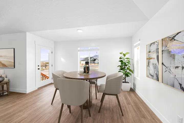 Wood-finish flooring, white painted walls, and abundant natural light