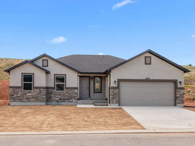 Single-story stucco exterior with stone veneer accents