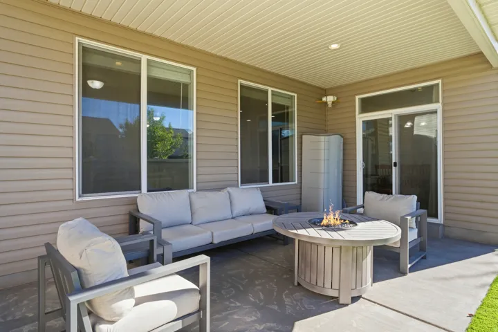Covered patio with recessed lighting, multiple windows, and a sliding glass door