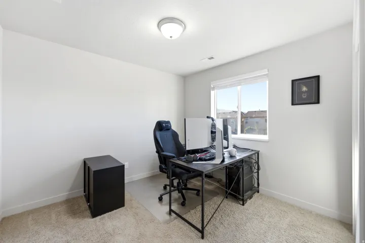 Recessed window with blinds, overhead flush mount light fixture, and light-toned wall paint