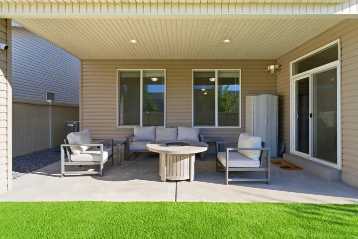 Covered patio featuring recessed lighting, a sliding glass door, and exterior windows