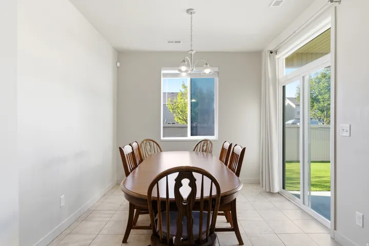 Tile flooring, white walls, and a multi-light chandelier