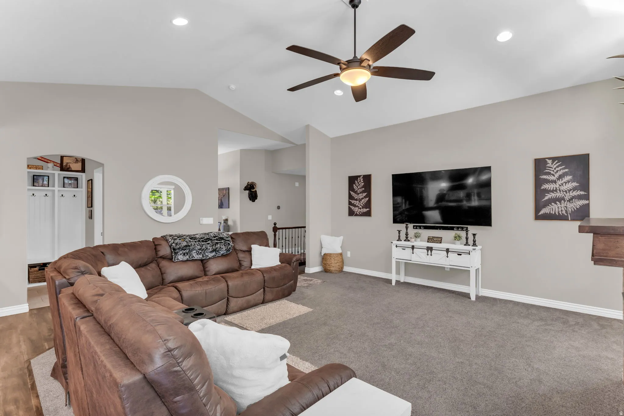 Vaulted ceiling with recessed lighting and a ceiling fan