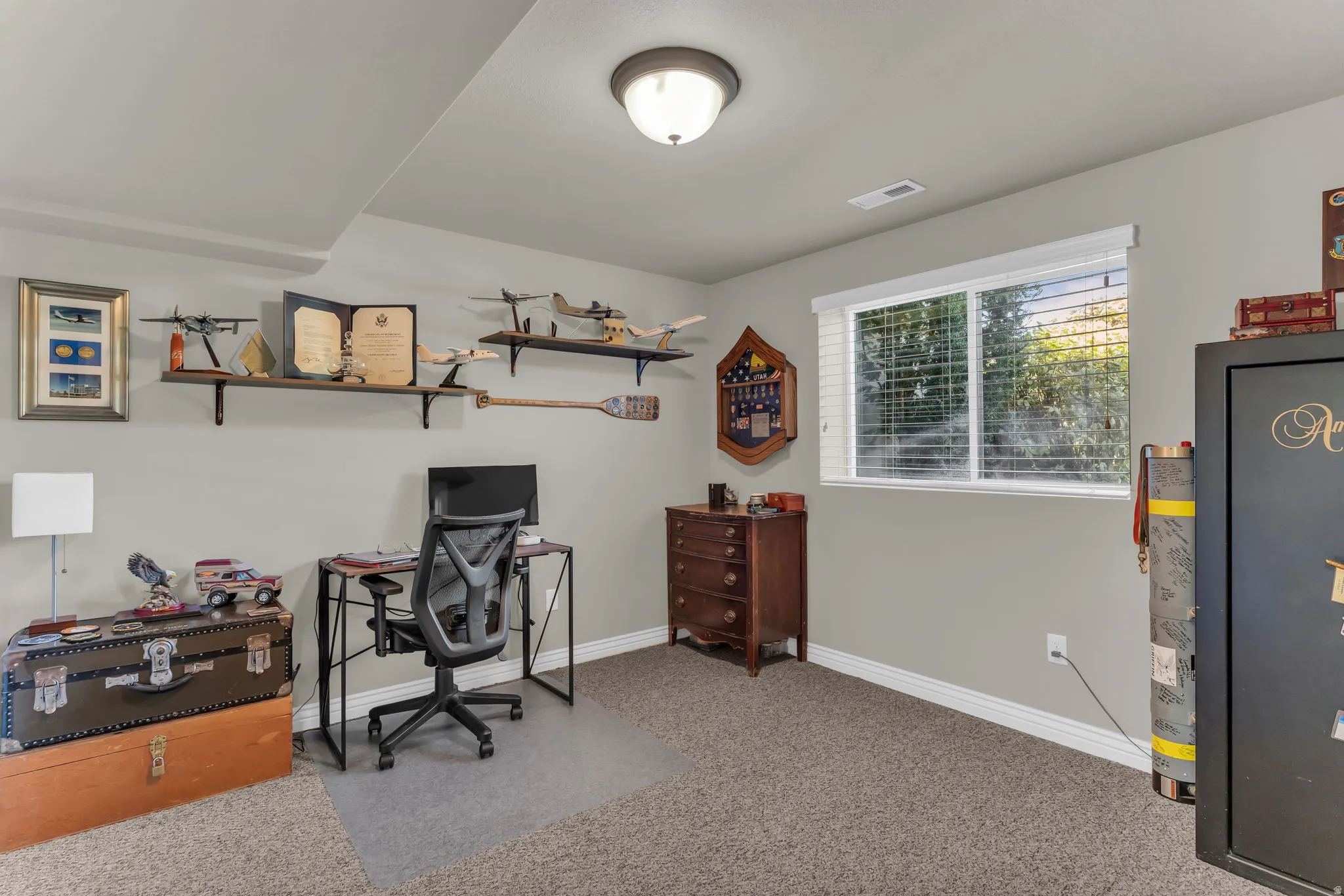 Recessed lighting, light-colored walls, window with blinds, and carpeted flooring