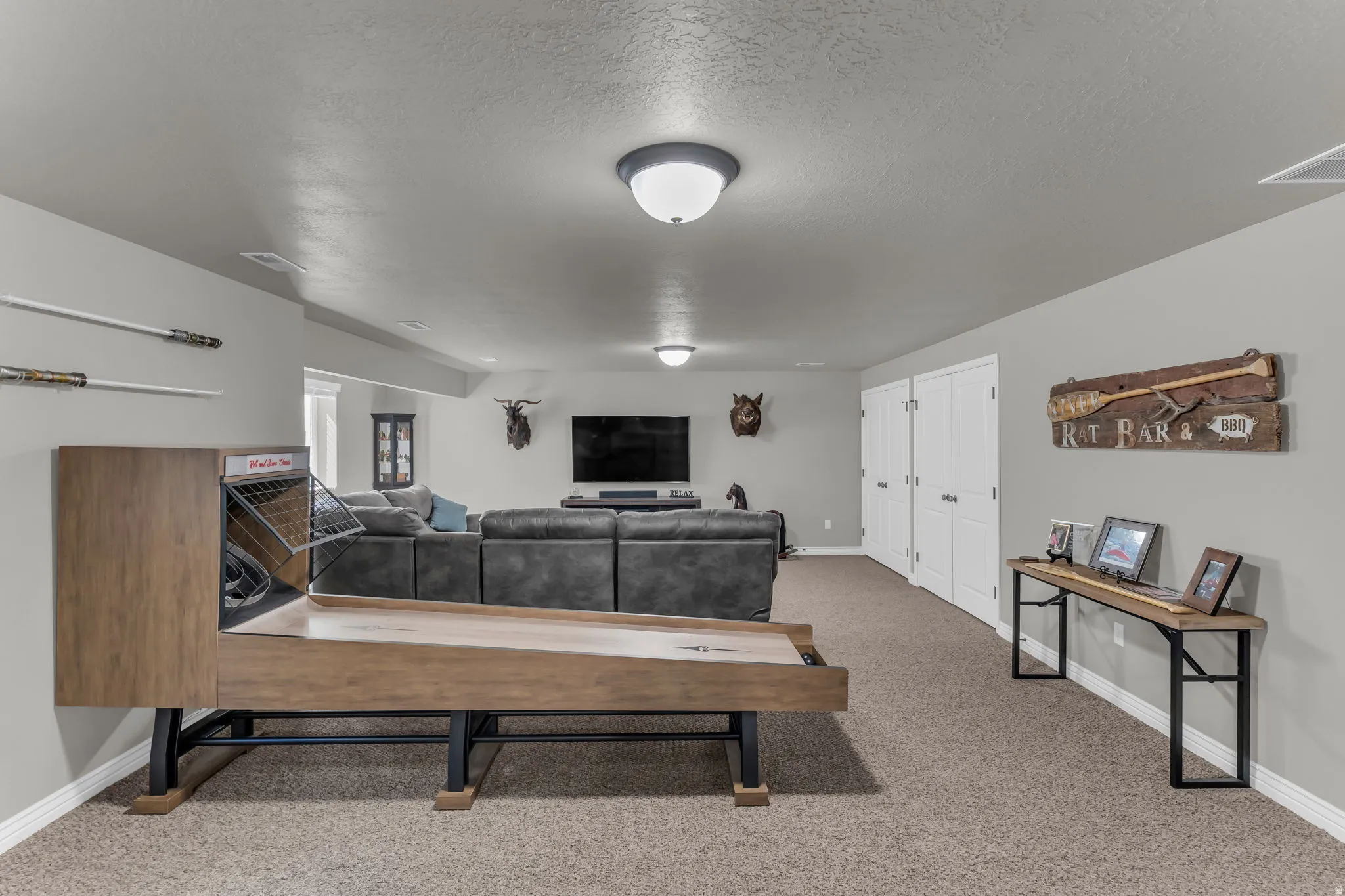 Recessed lighting, neutral wall paint, and durable carpeting