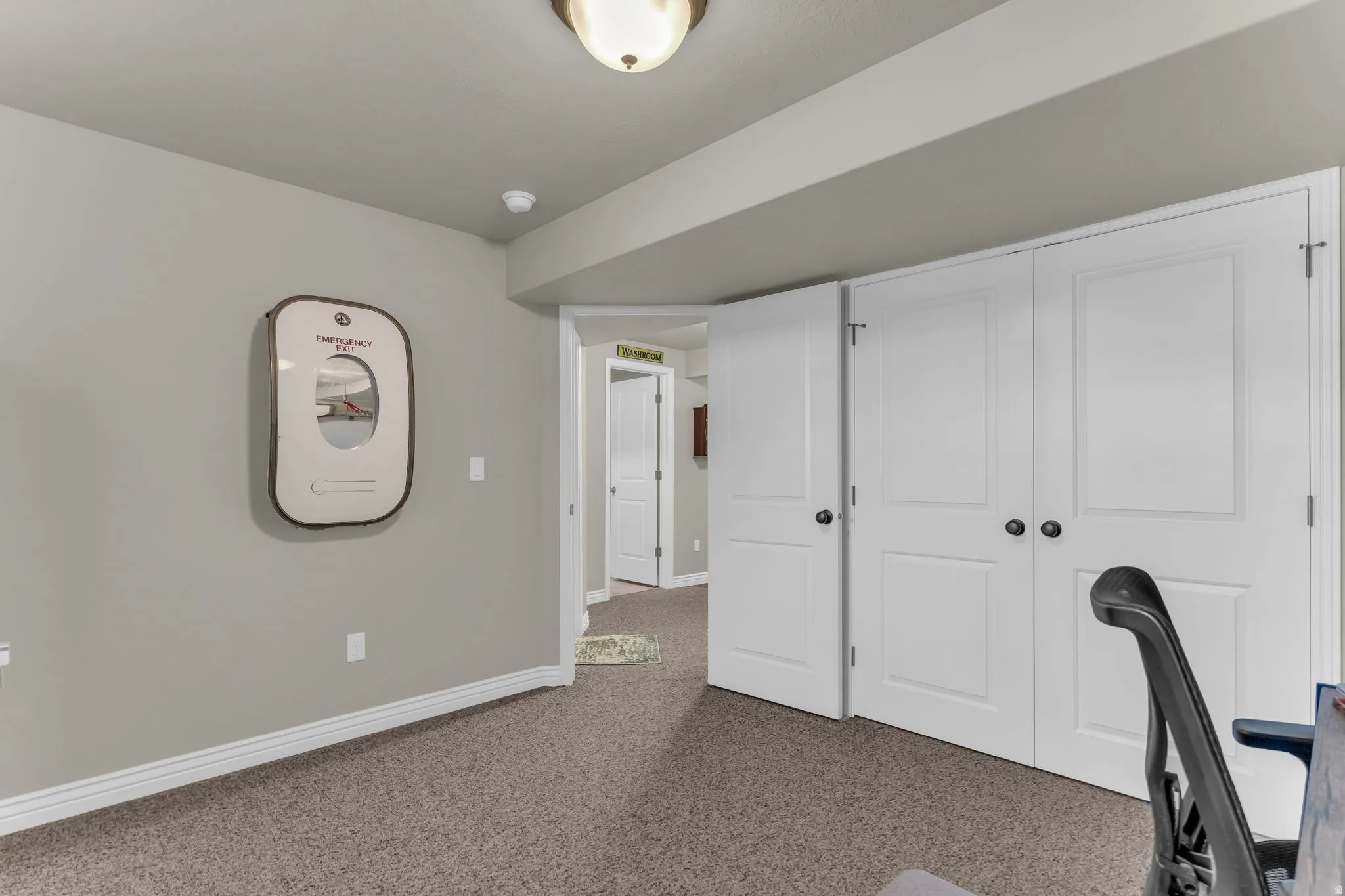 Neutral wall paint, textured carpet flooring, white trim, recessed lighting, and white panel doors