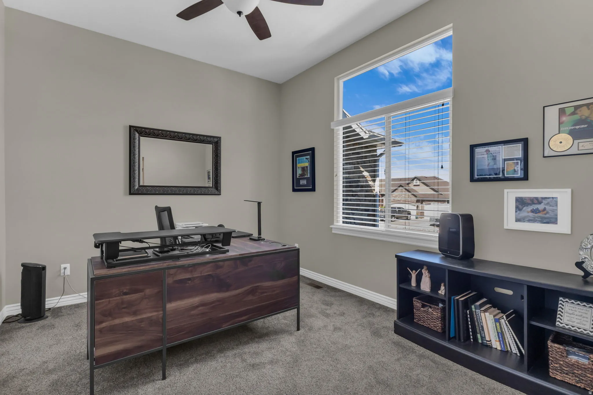 Vaulted ceiling with a ceiling fan, neutral wall paint, and carpet flooring