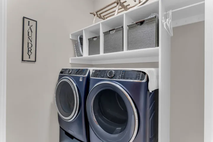 Built-in white shelving, integrated clothing rod, and neutral wall color