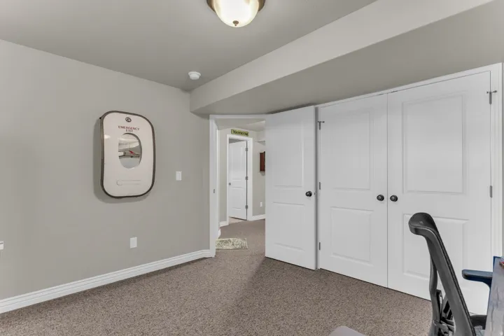 Neutral wall paint, textured carpet flooring, white trim, recessed lighting, and white panel doors