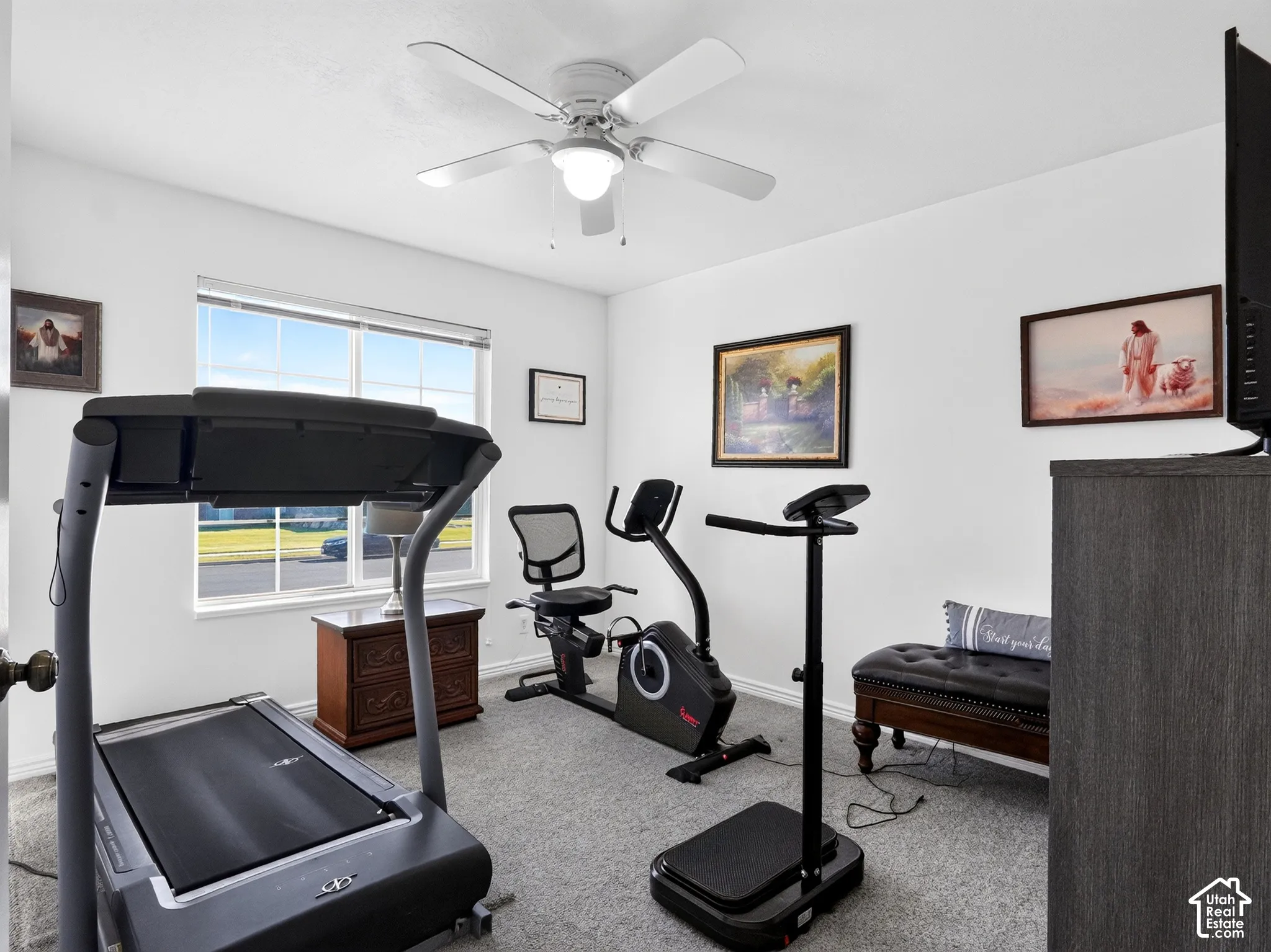 Recessed window with white trim, gray carpet flooring, white walls, and a ceiling fan with integrated lighting