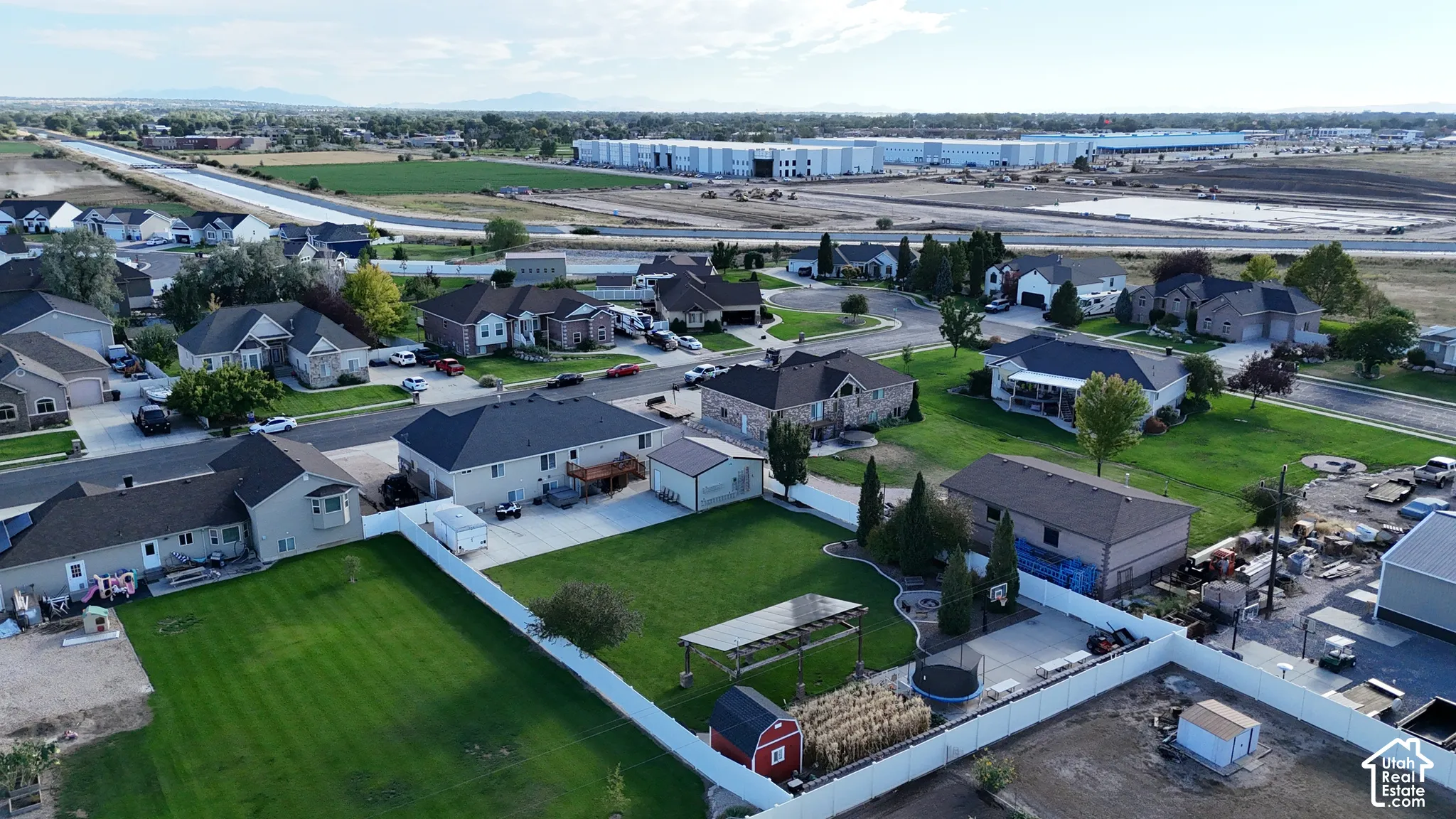 Expansive residential neighborhood featuring single-family homes, paved streets, and a blend of manicured lawns and developing land