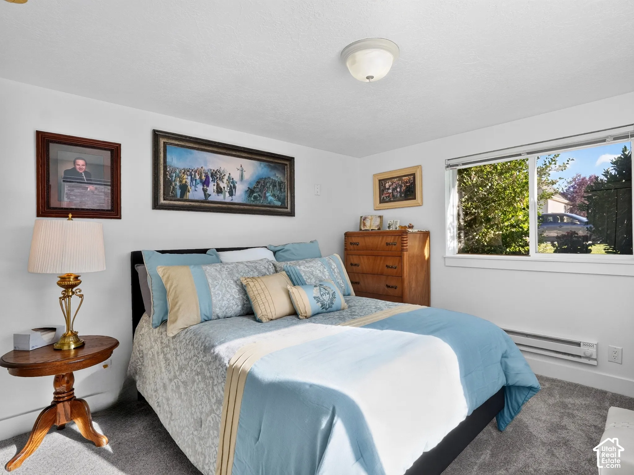 White walls complementing gray carpeting, with a window providing exterior visibility