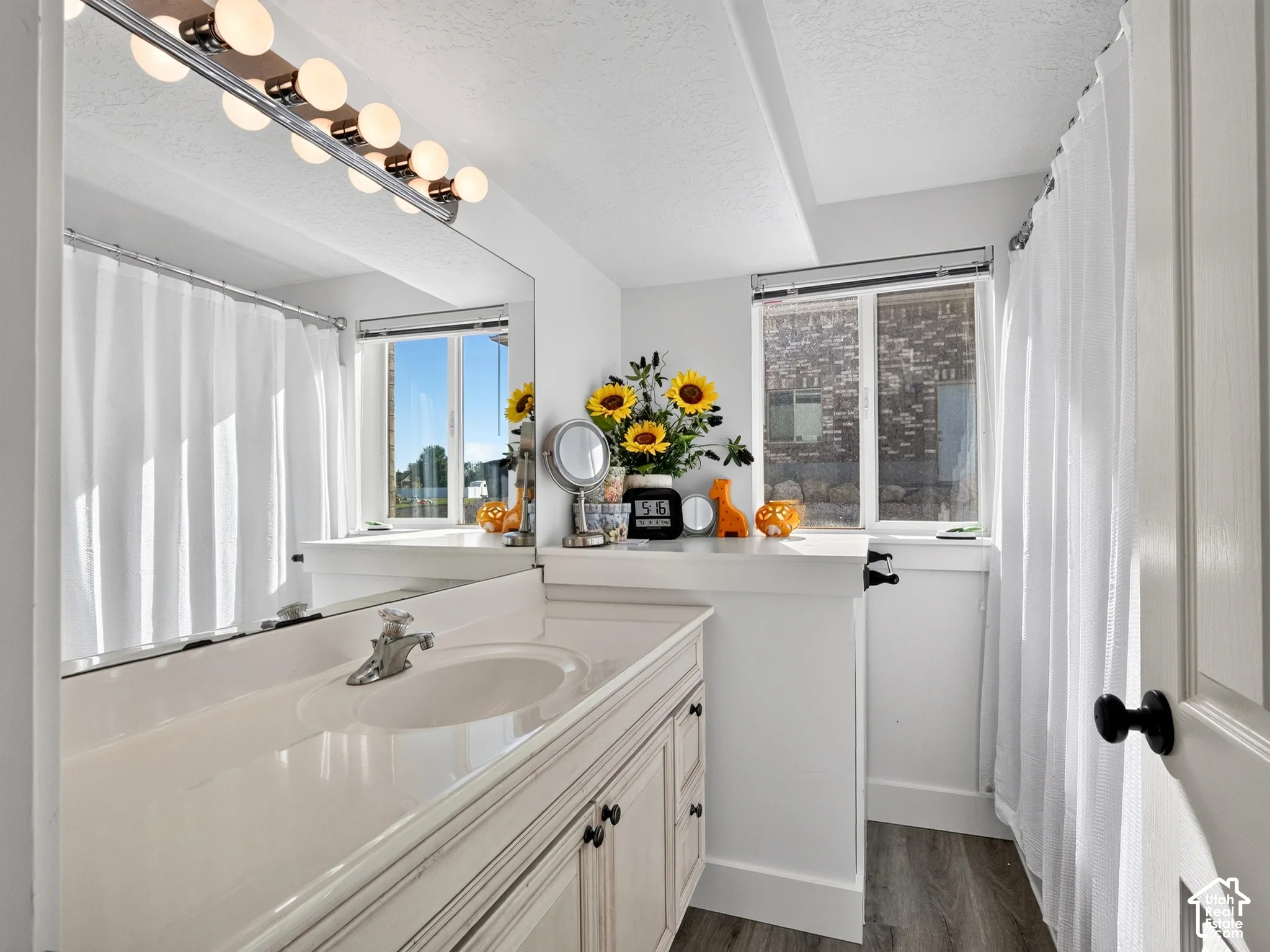 Vanity with integrated sink, chrome faucet, and cabinet storage