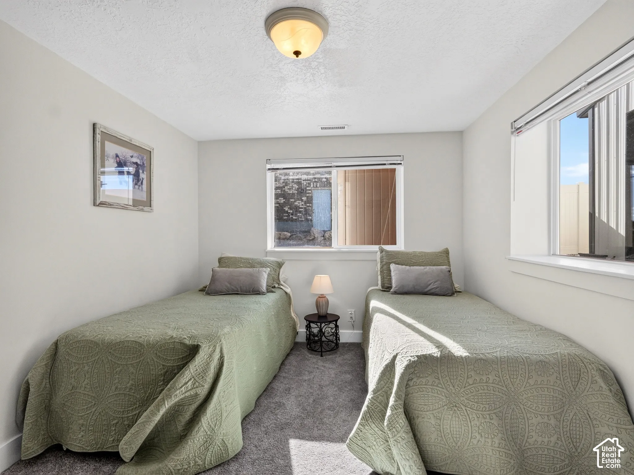 Neutral wall color, recessed lighting, carpeted flooring, and natural light from horizontal windows