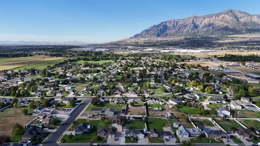 Residential community with mountain backdrop and verdant fields