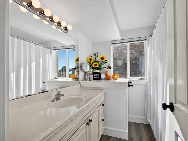 Vanity with integrated sink, chrome faucet, and cabinet storage