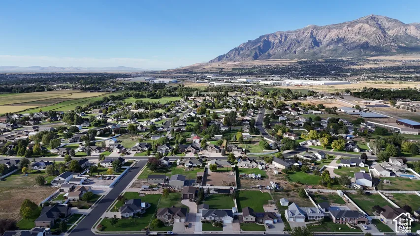 Residential community with mountain backdrop and verdant fields