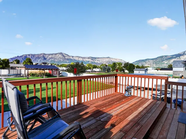 Expansive wood-finish deck with railing, providing an elevated outdoor living space